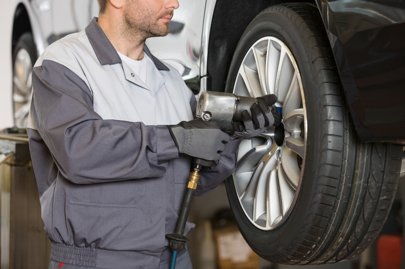 Mechanic repairing vehicle alloy wheel