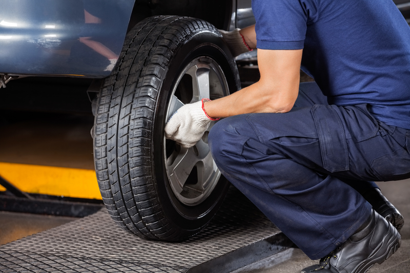 Mechanic fixing a car tyre