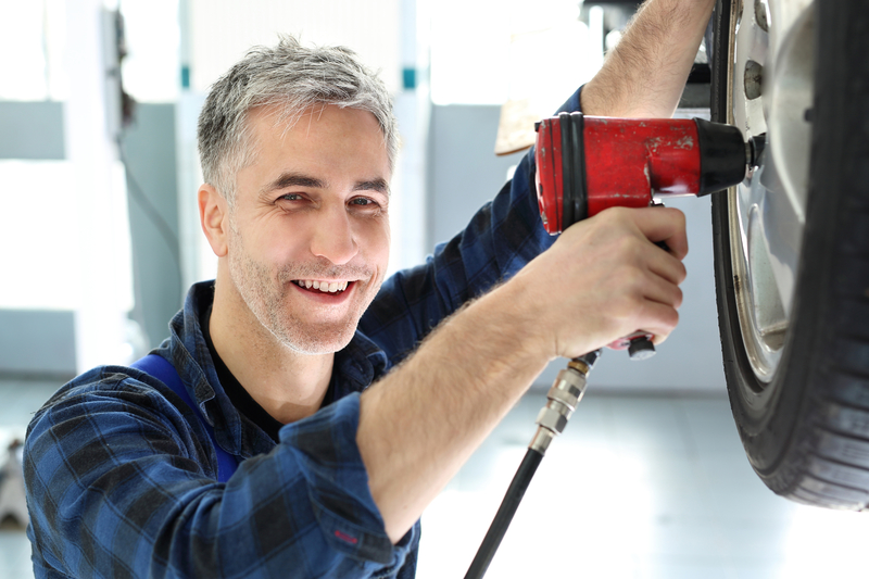 Man Repairing Alloy Wheel - wheel refurbishment