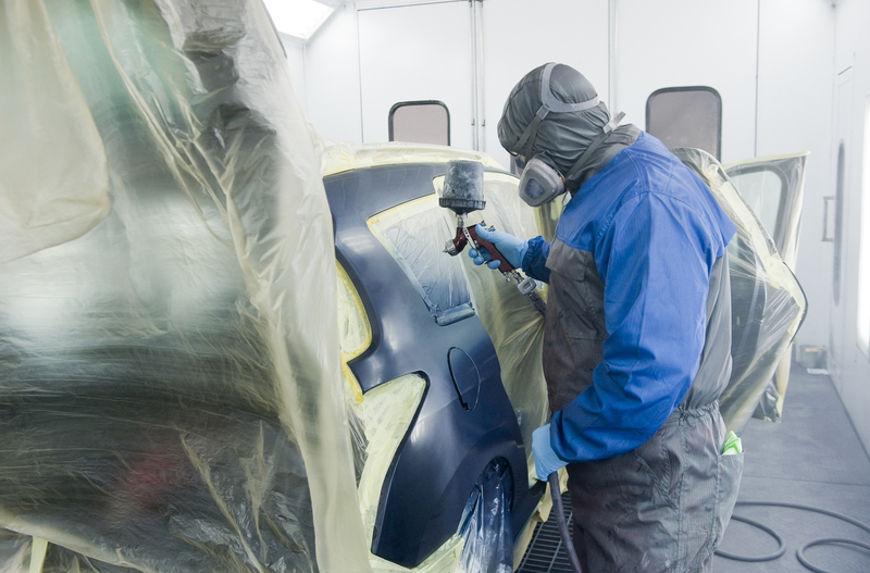 Professional at work, spraying a car